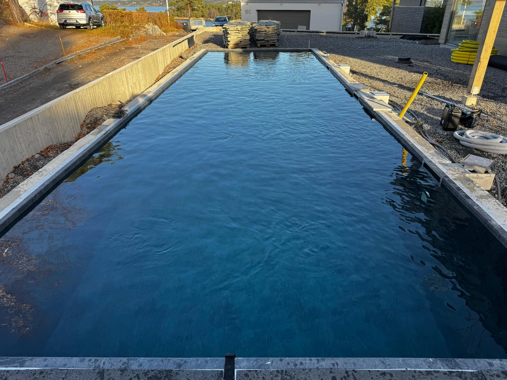 The completed pool lining filled with clear blue water